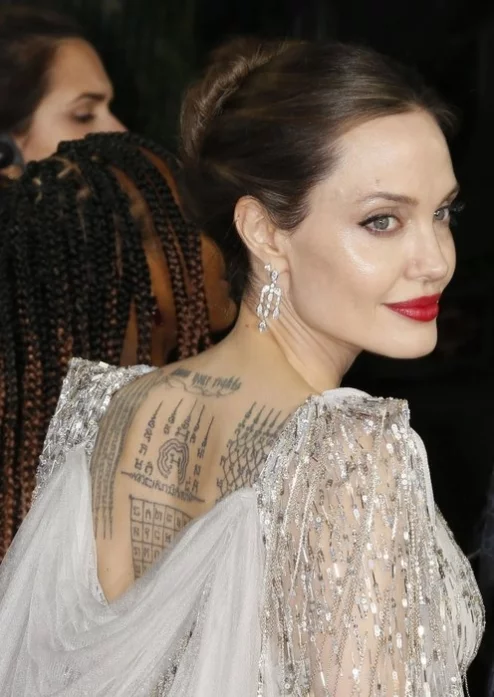Фото: Во время премьеры фильма Анджелина Джоли продемонстрировала свои татуировки на спине  2