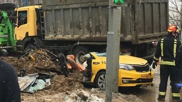 Фото: В Москве грузовик со щебнем засыпал машину такси 1