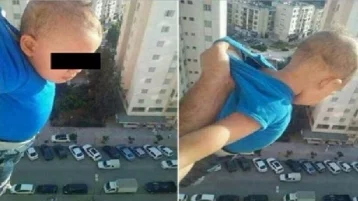 Фото: «1000 лайков, или я его бросаю»: мужчина вывесил сына из окна на 15-м этаже 1