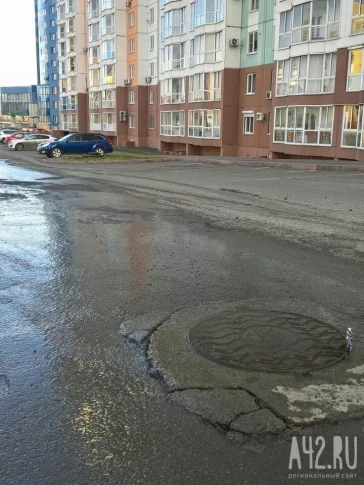 Фото: «Ждём образования провала»: в Кемерове из канализационного колодца вытекает вода 3